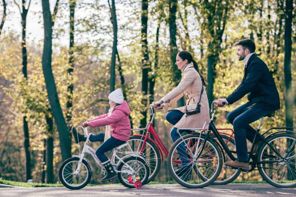 Family riding bikes together spending family time together