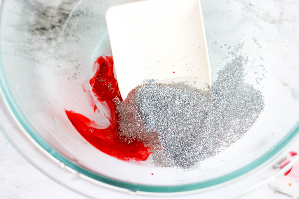 Stirring glitter and food coloring together to make bouncy balls from scratch 