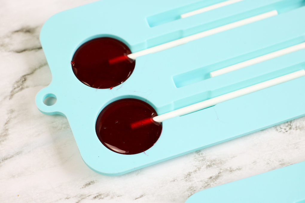 Make homemade koolaid lollipops with molds pour the liquid candy into the lollipop molds