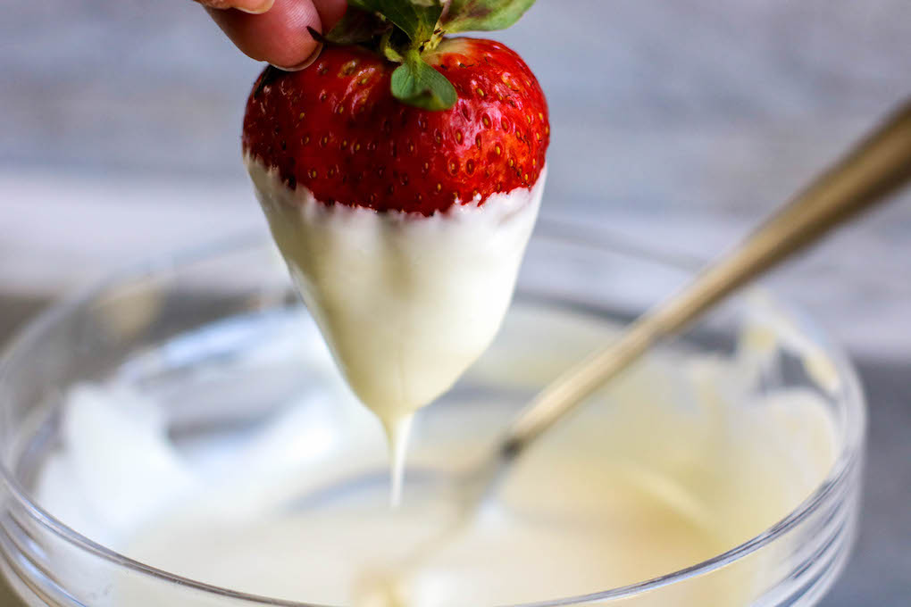 dipping in white chocolate strawberries