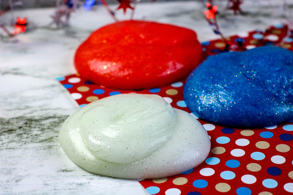 balls of red, white and blue slime Independence Day slime red, white and blue how to make colored slime using Elmers glue