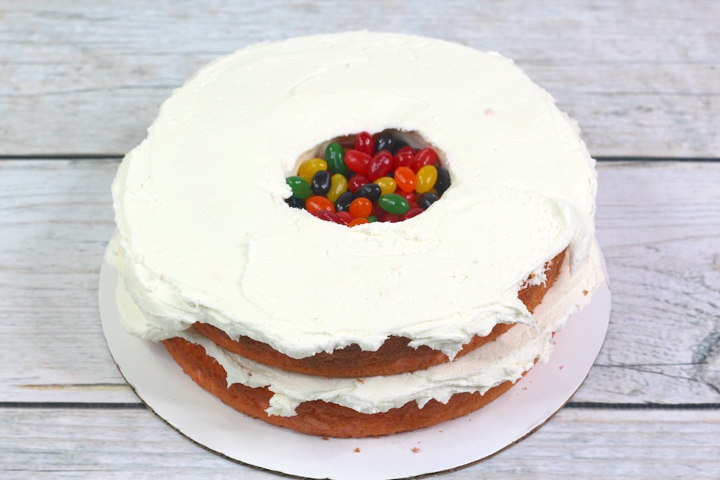 cake layer with frosting and a fun surprise in the center for the Jelly Bean Cake