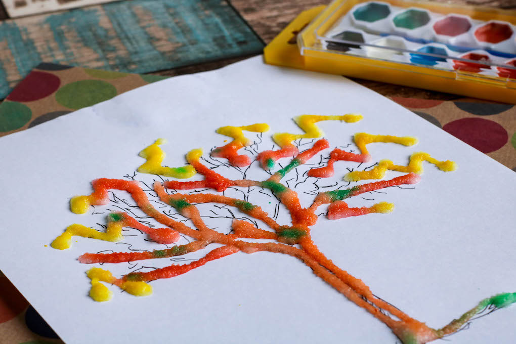 Close up of a colorful salt and watercolor painting of a tree