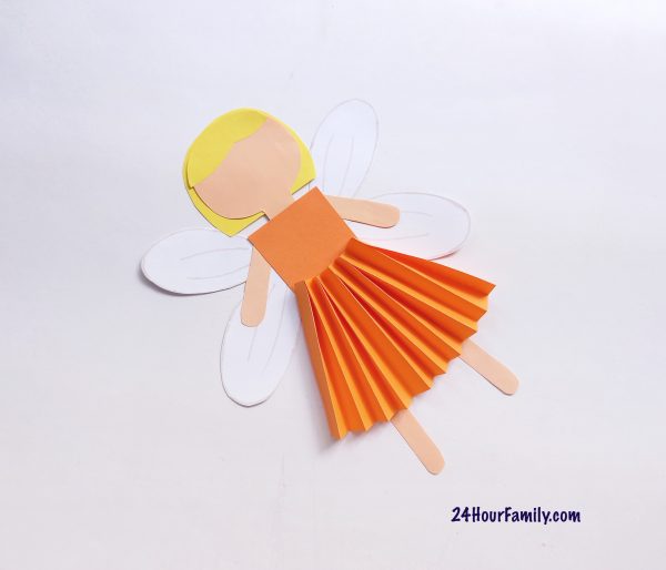 Connect the fairy’s wings to your paper doll craft on her back using glue.  This step will make her feel like a fairy doll!