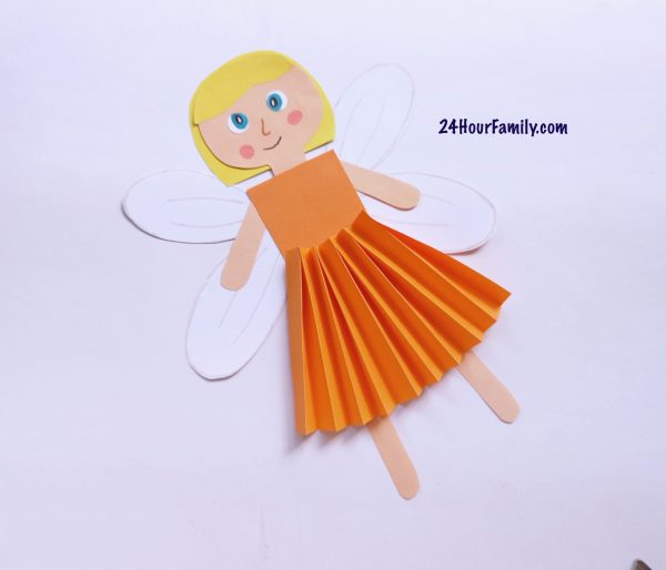 How to make a fairy paper doll face - Glue the eyes and use marker pens to draw the face on the fairy.