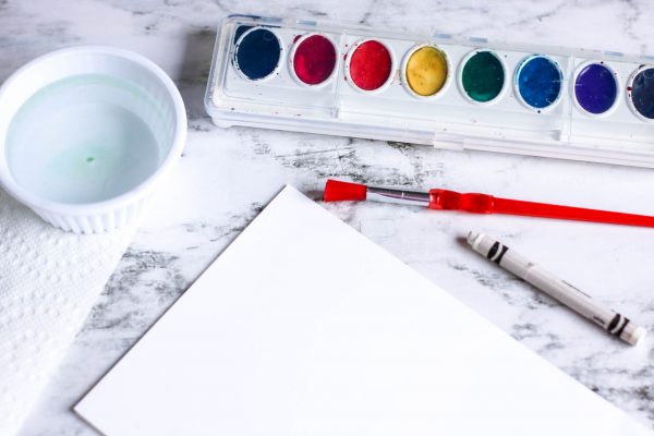 supplies needed to make a Mother's Day card includes white crayon or candle wax, watercolors and paint brush