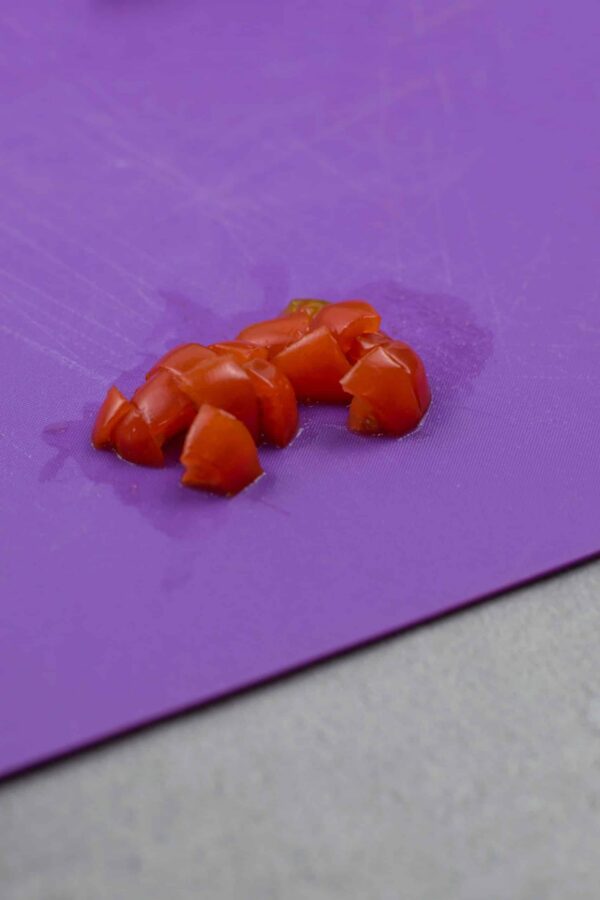 Diced cherry tomatoes for decorating the Grinch face.