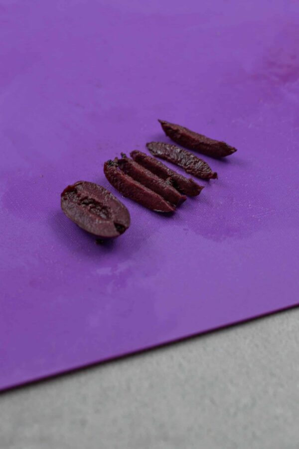 Sliced olives for decorating a Grinch guacamole face