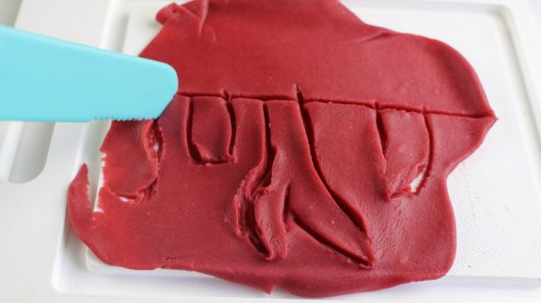 cutting the playdoh to look like volcanic eruption