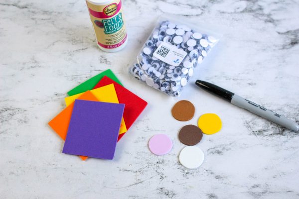 supplies needed to make superhero finger puppets using foam and googly eyes