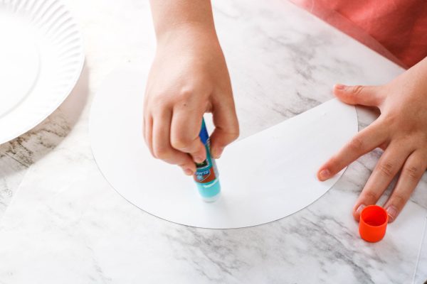 add glue to the back of the paper plate craft