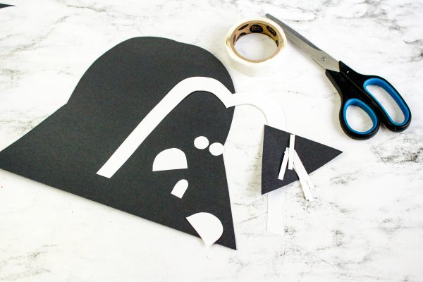 Place the mouth bars over the triangle cut from the black construction paper. 