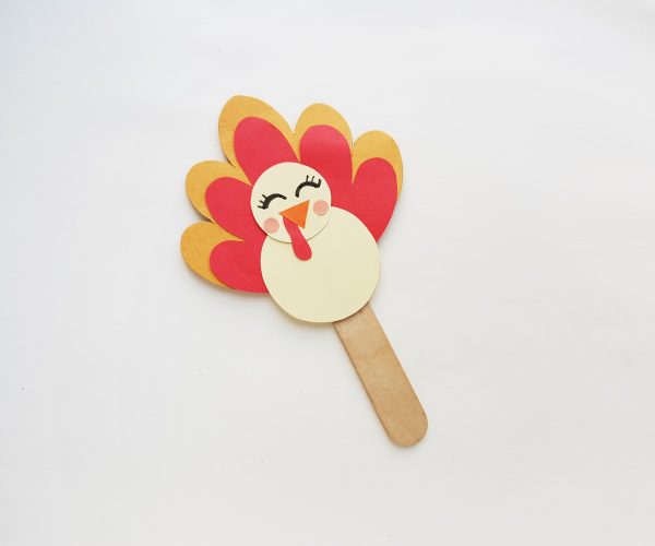 "Adding the popsicle stick to the preschool turkey craft with turkey template craft"