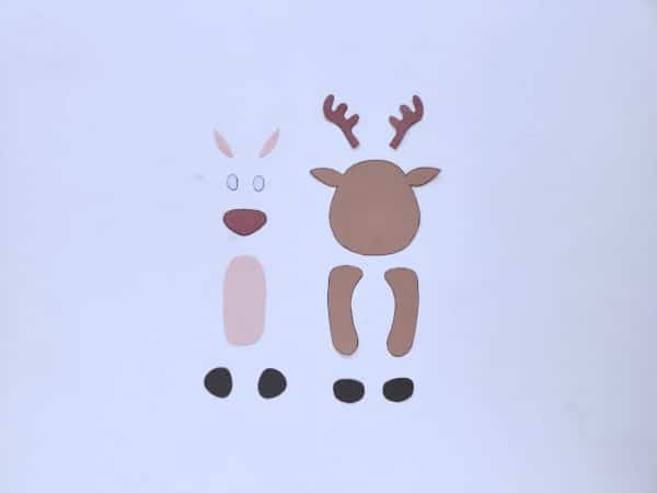 Cut out paper pieces for a reindeer: a brown body antlers white eyes black pupils red nose and legs