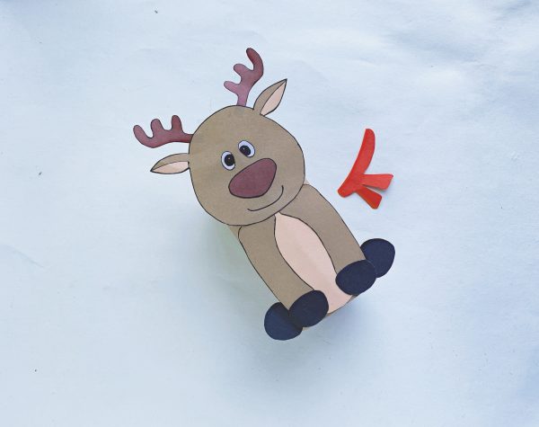 Paper reindeer with a red scarf beside it on a white background