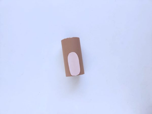 Brown paper roll with pink oval on it, on a white background