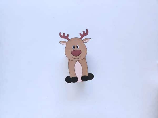 Pasted body parts of the paper reindeer: head and the lower part with antlers