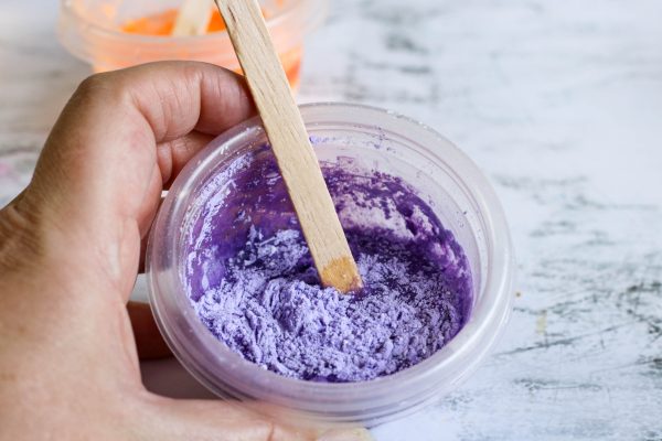 mixing purple pigment and cornstarch to make homemade paint