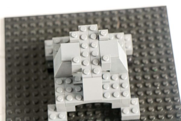 Top-down view of  LEGO tower structure on a black baseplate