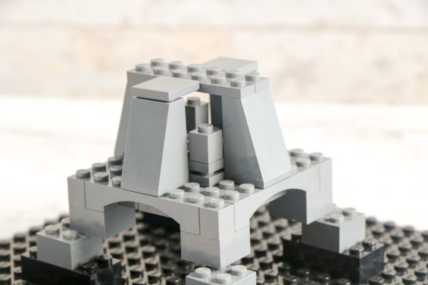 LEGO tower model with grey bricks on a black baseplate