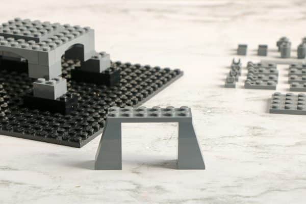 A LEGO structure resembling a bridge with two pillars and a flat top