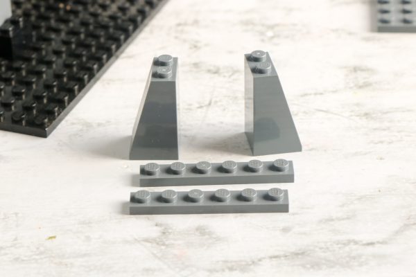 Two upright LEGO slopes with a horizontal LEGO pieces in front