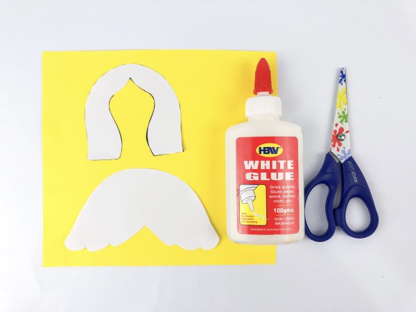 Angel cutout template with white glue and colorful scissors, How to Make an Angel Toilet paper Craft with Free Angel template, DIY Angel Toilet Paper Craft with yellow halo and wings, Angel Craft, Angel Toilet paper Roll, Angel' Wings, Crafts For Kids, Craft supplies for angel DIY: paper roll, scissors, markers, and glue