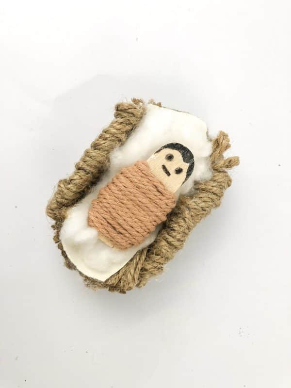 baby jesus in a manger craft using yarn and toilet paper roll