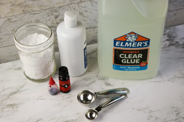 Easy DIY Strawberry slime recipe for kids to make at home, simple slime recipe containing elmer's glue, baking soda, borax contact lens solution essential oil