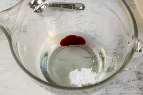 Easy DIY Strawberry slime recipe for kids to make at home, simple slime recipe containing elmer's glue, baking soda, borax contact lens solution essential oil