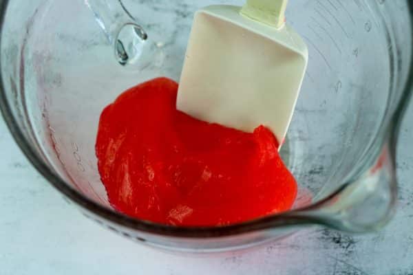 Easy DIY Strawberry slime recipe for kids to make at home, simple slime recipe containing elmer's glue, baking soda, borax contact lens solution essential oil
