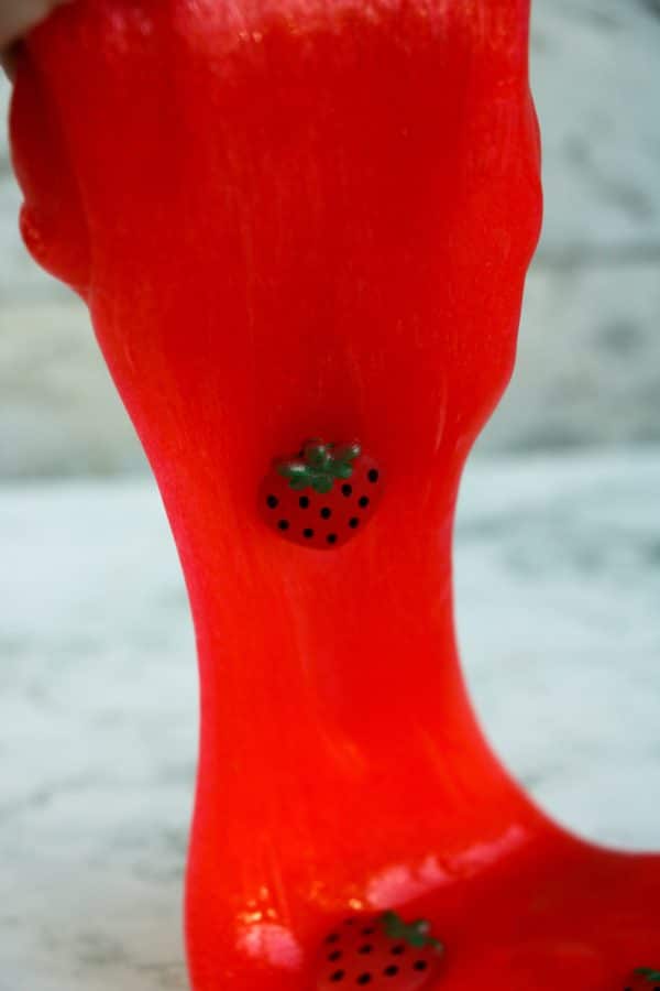 Easy DIY Strawberry slime recipe for kids to make at home, simple slime recipe containing elmer's glue, baking soda, borax contact lens solution essential oil