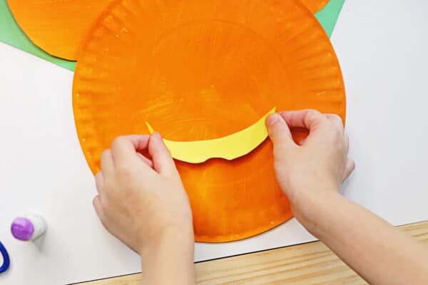 glue the cut out mouth to the mickey mouse paper plate
