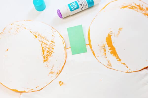 glue the cut out ears to the mickey mouse paper plate