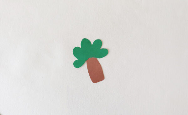 Cut-out paper tree for a dinosaur-themed popsicle stick puppet.