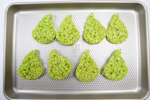 Tray with eight green Grinch-shaped rice crispy treats