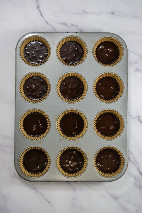 Adding the batter into the prepared cupcake liners