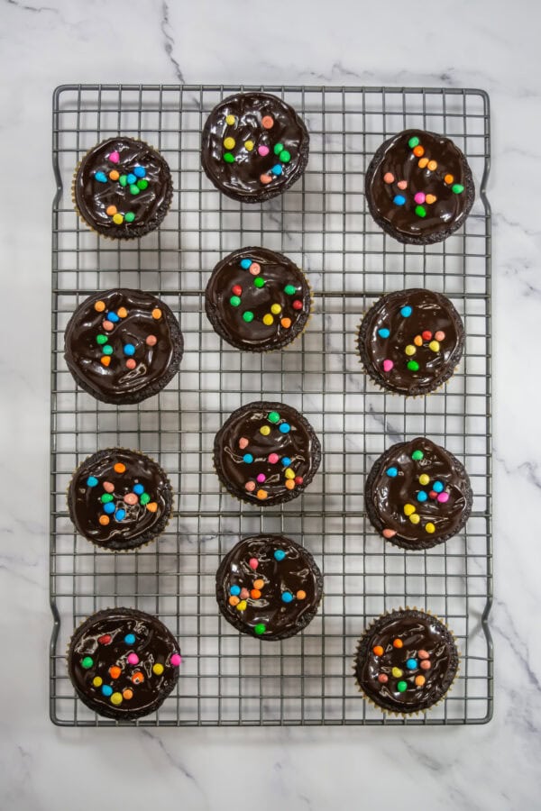sprinkle with colorful rainbow sprinkles and extra mini chocolate chips or candy pieces for that signature look.