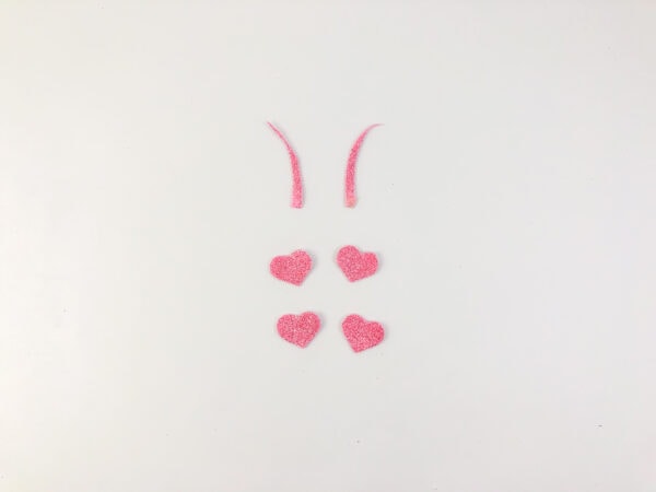 cut out pink glitter paper using the free ladyboug template