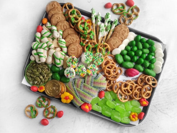 Irish party food, fun holiday snacks, Irish-themed party food, St Patricks Day appetizer ideas, green cheese board, rainbow and pot of gold snacks, shamrock-shaped snacks, party snack ideas, green candy board