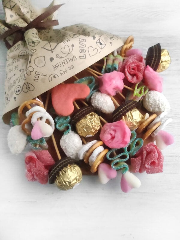 A charming Valentine's Day candy bouquet charcuterie board showcasing an elegant mix of candies, chocolates, and heart-themed treats, creating the perfect centerpiece for your holiday spread.