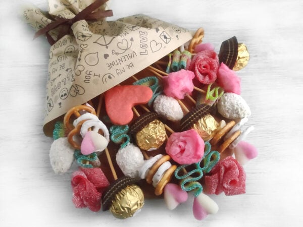 A charming Valentine's Day candy charcuterie board, filled with an assortment of chocolates, pink candies, and heart-shaped treats, designed to bring joy and sweetness to your loved ones.