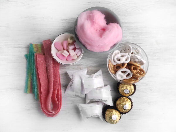 A delicious and visually appealing Valentine's Day candy bouquet charcuterie board, showcasing chocolates, pink and red gummies, and festive candies to celebrate the season of love.