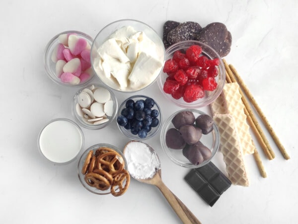 Ingredients for a charming dessert charcuterie board packed with pink and red-themed sweets, perfect for Valentine’s Day gatherings.