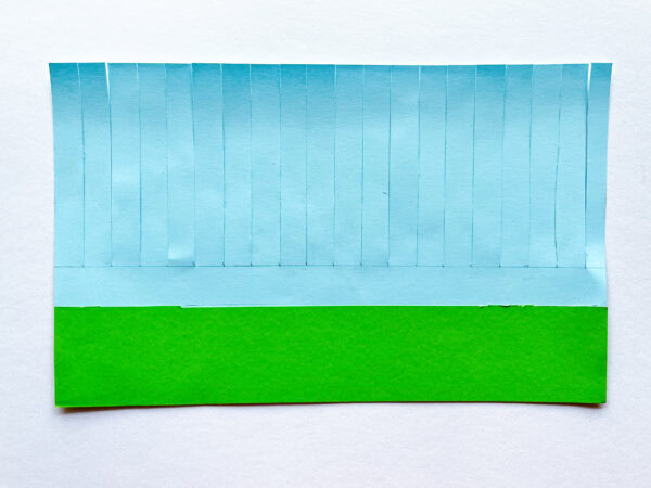 The green paper is attached at the bottom of the blue strips