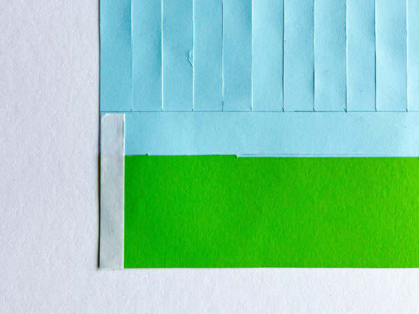 Close-up of the assembled blue and green sheet with a vertical strip of white tape along the side edge