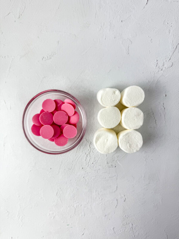 Pink candy melts and large marshmallows prepared for decorating the bunny tails and feet