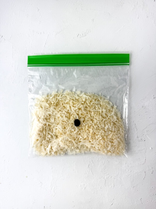 Shredded coconut in a ziplock bag with green food coloring added