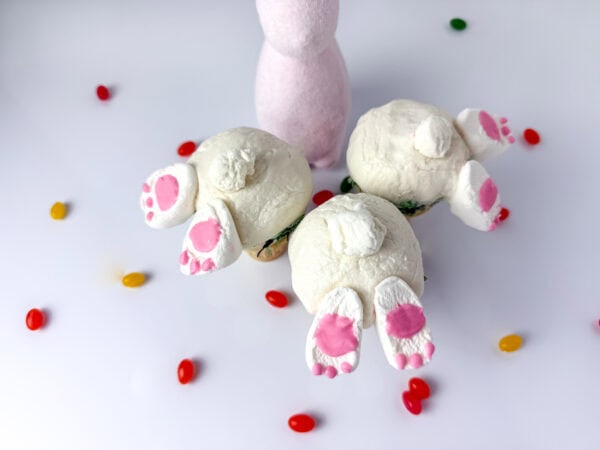 Multiple completed bunny tail cupcake cones with marshmallow feet and tails