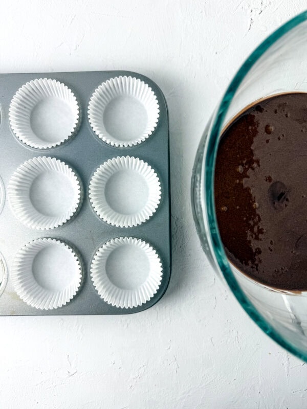 add the muffin liners to the pan and add the boxed cake mix to the muffin liners